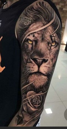 a man's arm with a lion and rose tattoo on the left side of his arm