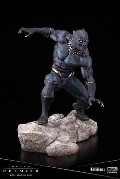 the black panther statue is posed on rocks