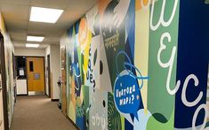 the hallway is decorated with colorful murals and posters