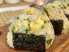 three sushi rolls on a wooden cutting board