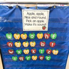 a bulletin board with apples and letters on it