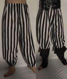 two men in black and white striped pants standing next to each other