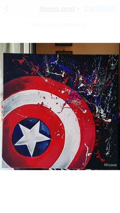 the captain's shield is painted in red, white and blue with paint splatters on it