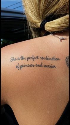 the back of a woman's shoulder with a tattoo saying she is the perfect combination of princess and warrior