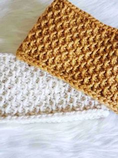 two crocheted headbands laying on top of each other