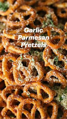 a plate full of pretzels covered in powdered sugar and sprinkled with parsley