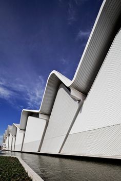 the exterior of an architectural building against a blue sky