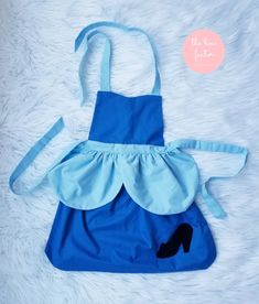 This listing is for one apron that is Cinderella themed. There are ties to go around the neck and waist. Since it's an apron it will fit a variety of ages. The model is 3 1/2 years old and is wearing size 4/5. This is would make a great halloween costume, especially if you live in climates requiring a coat during trick or treating. Also, makes a great gift!  Handmade. Easy on, easy off. Washable. Adjustable. Wash instructions: Wash with light colors on delicate cycle. Low dry. Can be ironed. Be Great Halloween Costumes, Cinderella Costume, Girl Apron, American Girl Doll Accessories, Princess Costume, Trick Or Treating, Gift Handmade, Girl Costumes, Doll Accessories