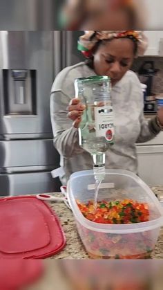 a woman pours water into a container filled with colorful candy and gummy bears