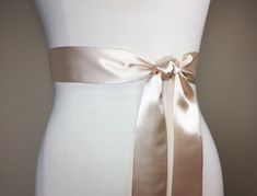 "Narrow Champagne Sash Champagne Satin Sash Champagne Beige Sash Belt Bridesmaid Sash Champagne Wedding Sash, Bridal Sash Satin Swank Now in a narrow version, this Satin Swank® reversible waist sash is the perfect finishing touch for your wedding, bridesmaid, or special occasion dress, or just the right piece to add instant polish to your dress or top. Depending on your waist size and the length you choose, you can wrap the sash around your waist once or up to three times. You decide whether to Satin Sash With Bow For Bridesmaids, Bridesmaid Sash With Satin Bow, Bridesmaid Satin Sash With Satin Bow, Bridesmaid Satin Sash With Bow, Wedding Satin Tie Back Sash, Wedding Sashes With Satin Finish, Bridesmaid Sash, Wedding Sash Belt, Waist Sash