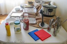 the table is covered with many different types of cooking utensils and sauces