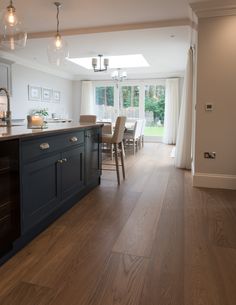 an open kitchen and dining room with wood flooring