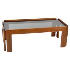 a coffee table with glass top and wooden frame on the bottom, against a white background