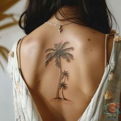 a woman with a palm tree tattoo on her back