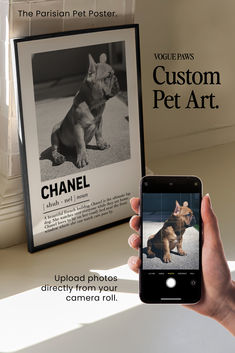 a person holding a cell phone in front of a poster with a dog on it