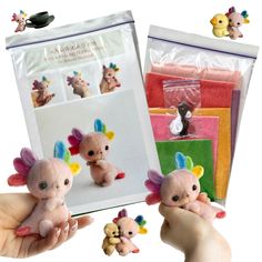 the small stuffed animals are being held in front of an envelope with other items inside