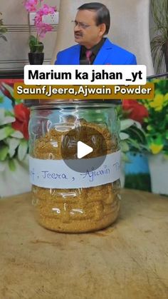 a jar filled with food sitting on top of a table next to a planter