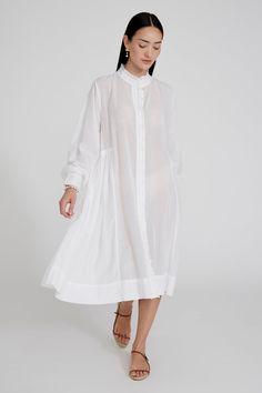 Cotton and viscose blend button down dress with ruffled details and balloon sleeves. 55% Cotton, 45% Viscose. 22.5" Bust, 23" Sleeve, 54.5" Bottom Width, 51" Total Length. One size: Fits sizes S-L. Machine wash cold. Made in India. Spring Daywear Puff Sleeve Dress With Relaxed Fit, Spring Daywear Relaxed Fit Puff Sleeve Dress, Spring Puff Sleeve Relaxed Fit Dress For Daywear, Spring Relaxed Fit Puff Sleeve Dress For Daywear, Daywear Puff Sleeve Dress With Gathered Sleeves, Voluminous Bishop Sleeve Spring Dress, Daywear Puff Sleeve Dress With Relaxed Fit, Billowy Long Sleeve Puff Sleeve Dress For Spring, Spring Voluminous Bishop Sleeve Dress