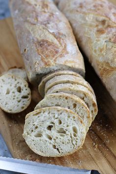 a loaf of bread sitting on top of a wooden cutting board