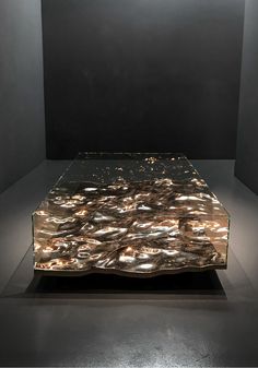 a glass table sitting on top of a black floor