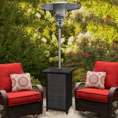 an outdoor patio heater with two chairs around it