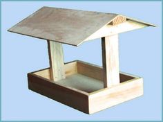 a wooden bird feeder with a roof on top