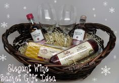 a basket filled with wine bottles, cheese and other condiments in front of snowflakes