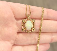 "Stunningly beautiful ornate vintage style filigree solitaire pendant! Featuring a gorgeous natural colorful and iridescent 11x9mm oval White Fire Opal cabochon, set in 14K solid yellow gold. Such a beautiful array of vibrant colors, splashed within an elegant firey Opal. New 18\" 0.8mm gold vermeil (14k plated over sterling silver) box chain included! The pendant is marked 14K and acid tested. The pendant measures 23x12mm The pendant weighs 3.13g Vintage condition: Very Good (some minor wear on Diffraction Of Light, Adornment Jewelry, Silver Box, Natural Rainbow, Yellow Gold Pendants, Ethereal Beauty, Minimalist Rings