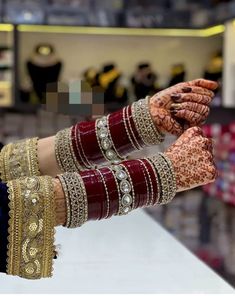 a woman's hands with hennap and bracelets on display in a store