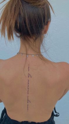 the back of a woman's neck with writing on it