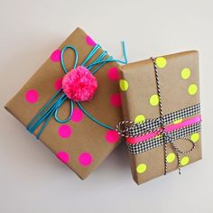 two presents wrapped in brown paper with pink and green polka dots