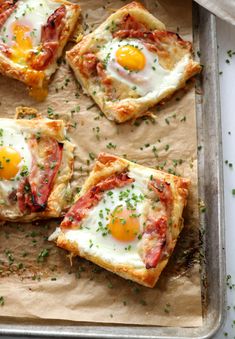 four pieces of pizza with eggs on top