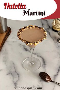 a martini in a glass with nuts on the rim