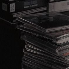 a stack of cd's sitting on top of a table next to each other