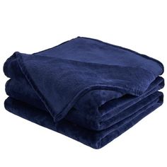 two blankets folded on top of each other in dark blue color, with one blanket folded over it