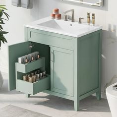 a bathroom with a sink and green cabinet