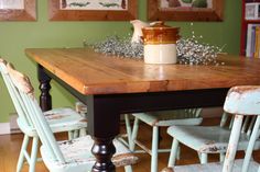 a wooden table with chairs around it