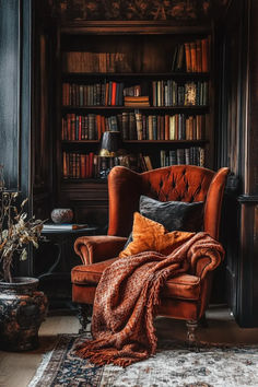 an orange chair sitting in front of a book shelf filled with books