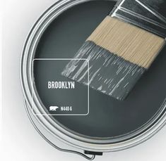 a paint can with a brush in it and the words brooklyn on top of it