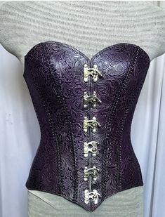 It is handmade embossed leather corset with hand-sewn leather detailing. At front is closed with Lock and back side is adjustable with buckles. We used about 2 to 2.2 mm thick handmade leather. It is hand dyed handmade leather. It is crazy for Gothic, Steampuck costumes and medieval events and Larp.   Corset is hand made from sturdy top-grain leather.  Size is available from 30 to 46 inch, please check our size chart. Bust size in size-chart. DETAILS: ► 100% Handmade ► 100% Genuine leather ► Mad Armour Corset, Purple Armor, Pirate Corset, Steampunk Medieval, Leather Armour, Corset Steampunk, Leather Corset Belt, Purple Gothic, Warrior Outfit