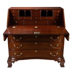 an old fashioned wooden desk with drawers