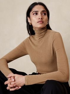 A classic turtleneck made in our new wool blend jersey, selected for its lightweight warmth and buttery handfeel.  Stretches to fit.  Turtleneck.  Stretches to fit.  Long sleeves.  Hip length.  Model: Size S, 5'10" (178cm). Turtleneck And Tshirt, Womens Tank Tops Summer, Classic Turtleneck, Turtleneck Jumper, Business Skirt, Turtleneck T Shirt, Turtle Neck Jumper, Fitted Turtleneck, Sheer Shorts