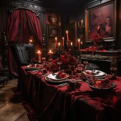 a table set with plates and candles in a dark room