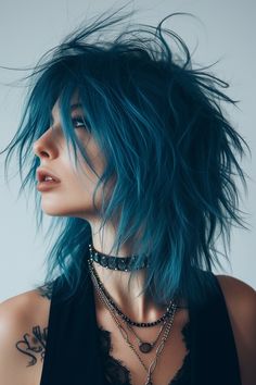 The medium-length shaggy mullet for women in a cool ocean blue is perfect for those seeking a refreshing and unique look. This hairstyle combines a trendy color with the classic mullet shape. Read more here. Shaggy Blue Hair, Blue Mullet, Rocker Hair, Short Grunge Hair, Mullet Hairstyle, Hair Styler, Alternative Hair, Grunge Hair, Model Hair