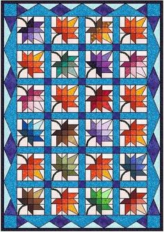 a quilt with many different colors and shapes on it, including leaves in the center