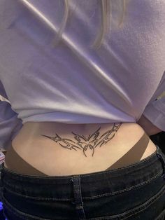 a woman with a butterfly tattoo on her lower back