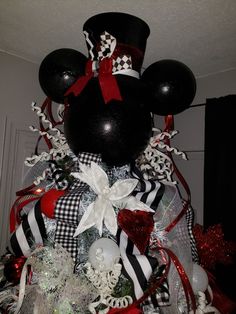 a mickey mouse christmas tree with red, white and black decorations