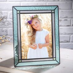 PRICES MAY VARY. This 5x7 glass picture frame features a combination of Windsor blue, pale green and clear glass trimmed with a beaded edge, the elegant styling will add a touch of sophistication to any home or office décor. Add a cherished photo and this frame will make the ideal keepsake gift for a baby, graduation or wedding anniversary. This stained glass picture frame has been made with lead free solder to protect you and the environment. The metal trim and solder have been stained with an Desk Table Top, Green Corner, Glass Picture Frame, Glass Picture Frames, Beaded Edge, Religious Wedding, Pale Turquoise, Mini Lamp, Winter Home