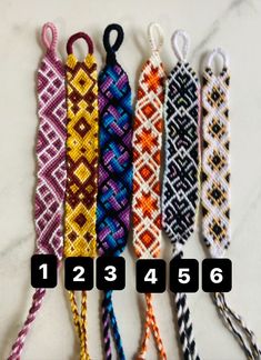 four different colors of bracelets with numbers on the bottom and one in the middle