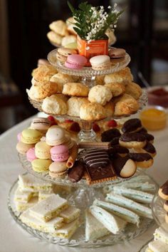 there are many different types of pastries on the table and in the glass plate